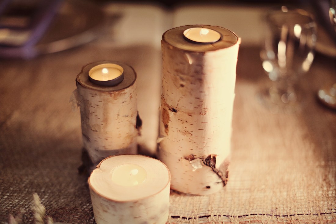 Birch tree candle holders added some light to their tablesacpe at the head table.