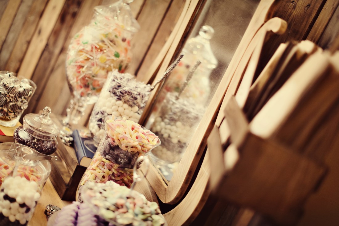 The candy buffet sat on our antique vanity dresser framed by our 10' x 10' barnwood backdrop.