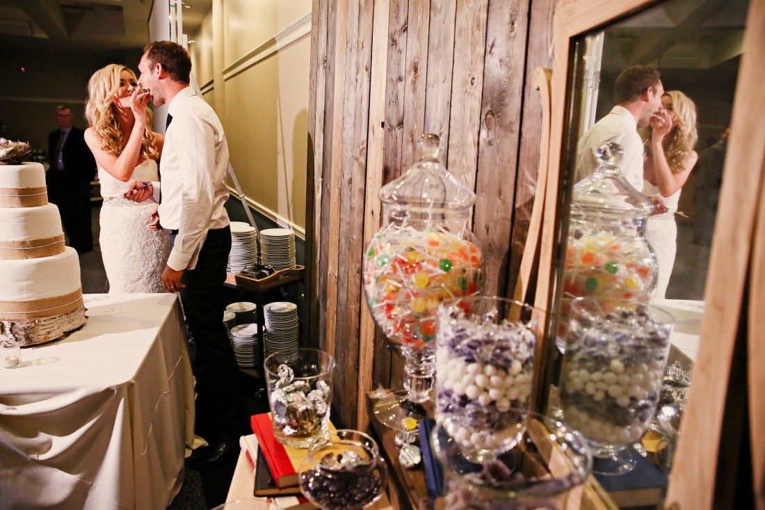 We set our barnwood wall up to use as a background not only for the candy buffet but for the cake as well. Which works wonderfully for photos of the bride groom during their cake moment.