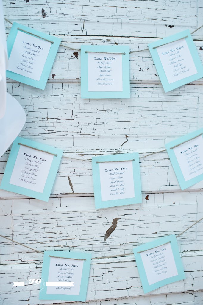 Seating chart displayed in crisp mint on a charming door.